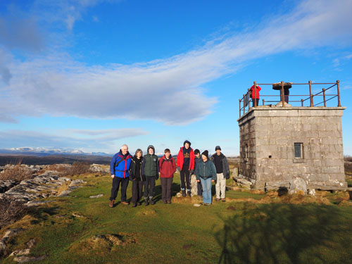 Group photo at summit with Lakeland fells in background