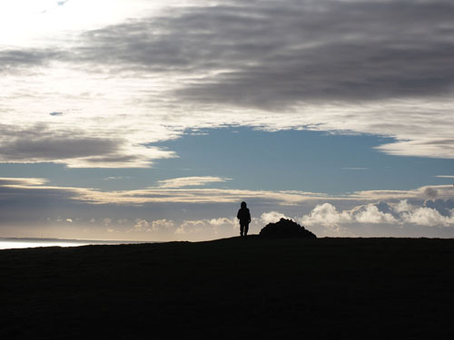 Silhouette of Jason by cairn near end of walk